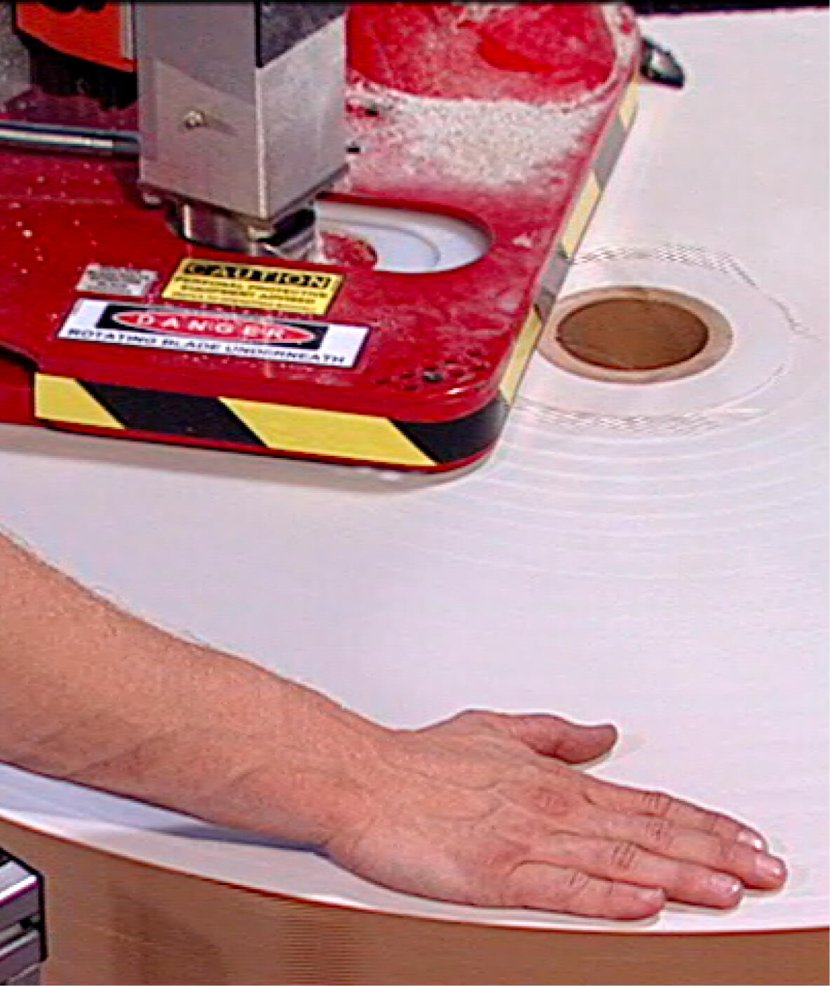 Close-up of the plunge-cutter blade dividing a paper roll